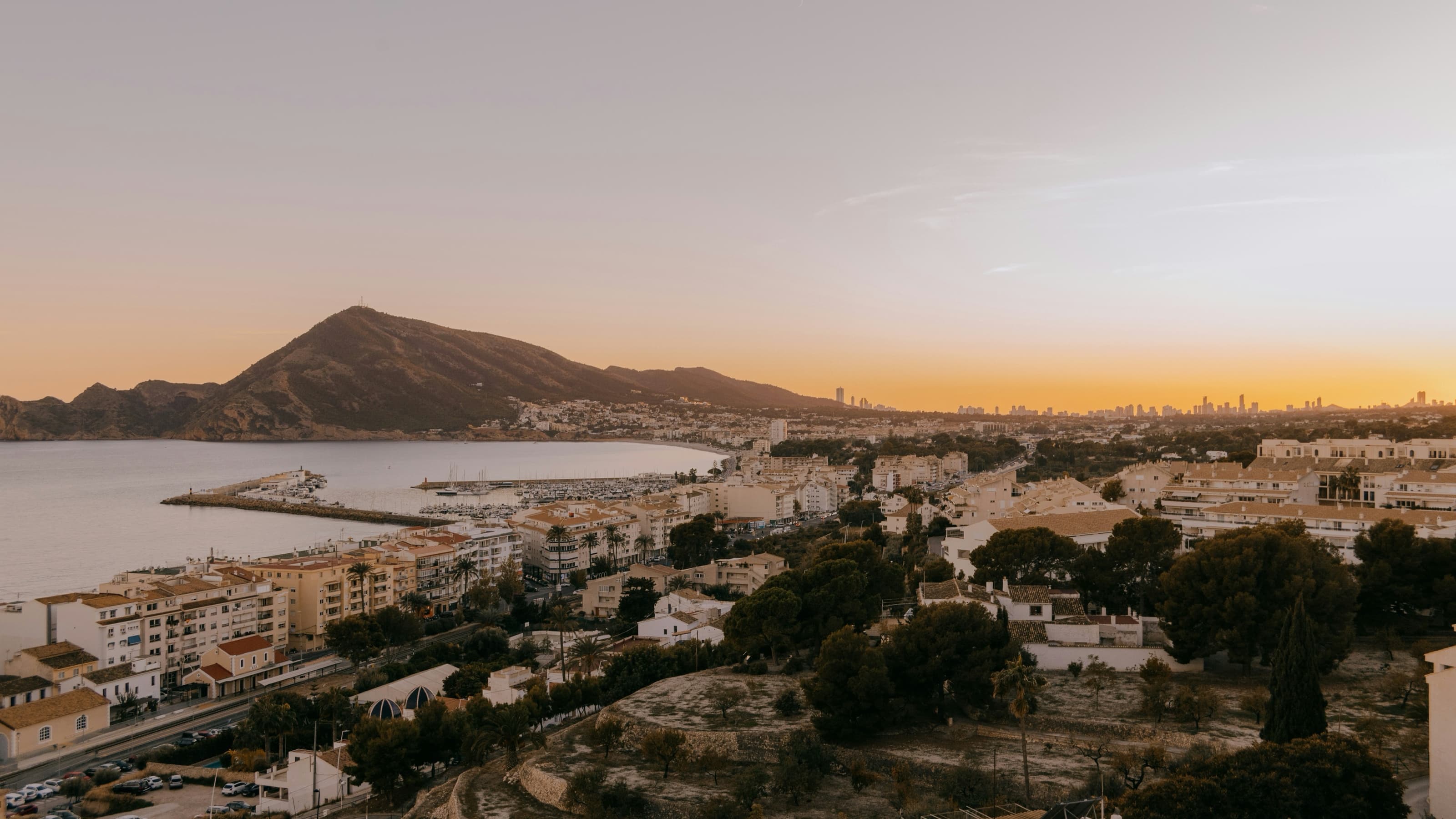 Vue aérienne de la vieille ville blanche d’Altea et de sa baie au crépuscule, avec le port de plaisance au premier plan